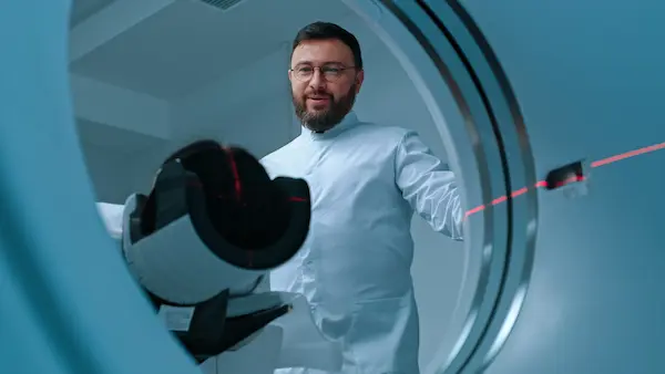 A Raleigh MRI for injury, a doctor loads a patient into a scanner machine.
